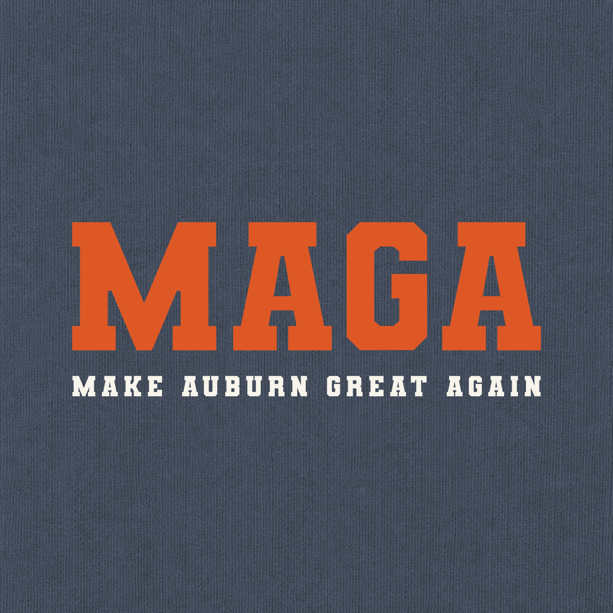A close-up of a navy blue textured fabric, likely a t-shirt or sweatshirt, featuring a graphic print with the word 'MAGA' in large orange varsity-style block letters and the phrase 'MAKE AUBURN GREAT AGAIN' in smaller white block letters underneath.