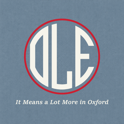 Close-up of Ole Miss red and ivory Oxford artwork on Blue Jean Comfort Colors fabric